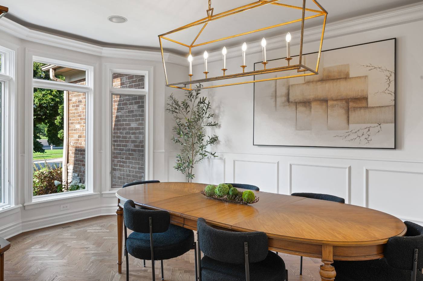 Dining room with bay window, wainscoting and herringbone floor