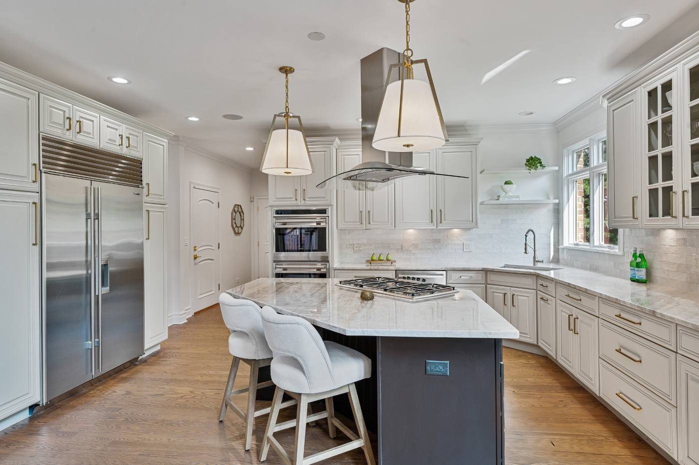 Kitchen with built-in refrigeration, double ovens and seating at the island