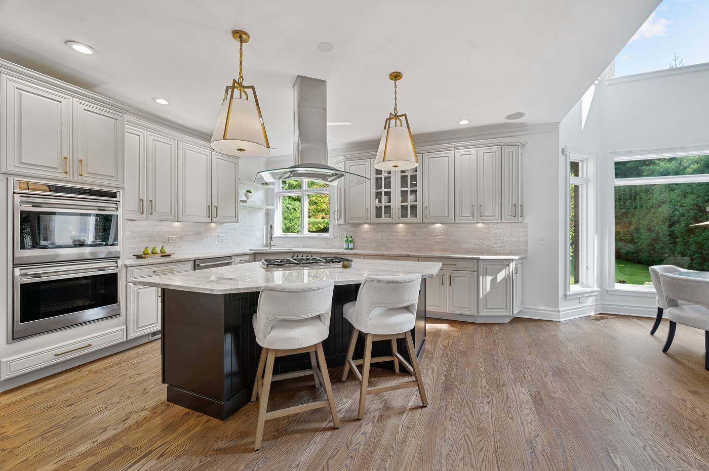 Kitchen opening to the breakfast room and the two-story window wall