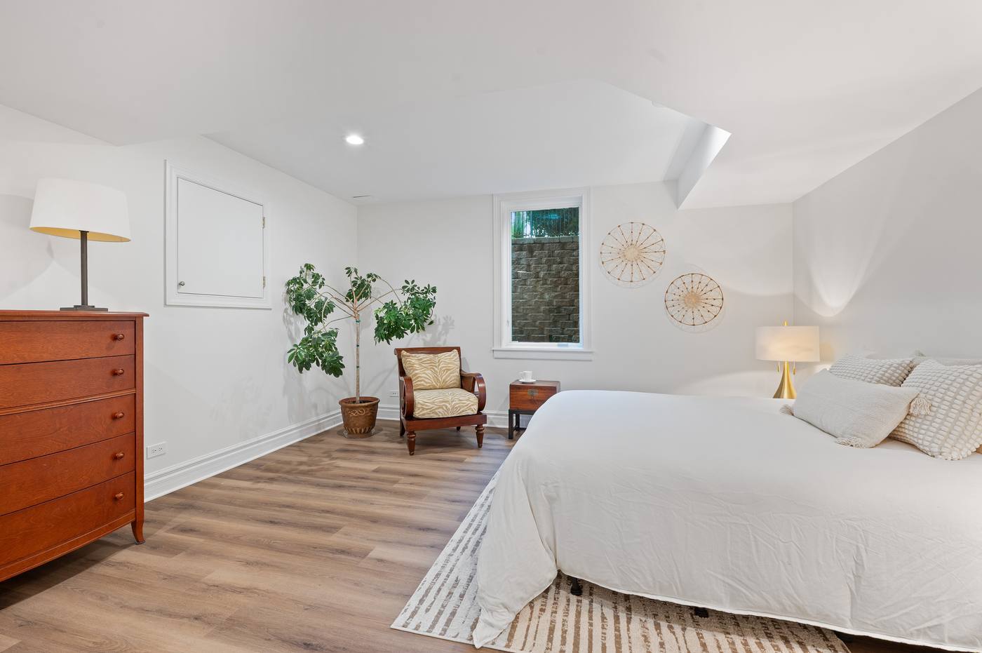 Lower-level bedroom with above-grade window, the sixth bedroom in the house