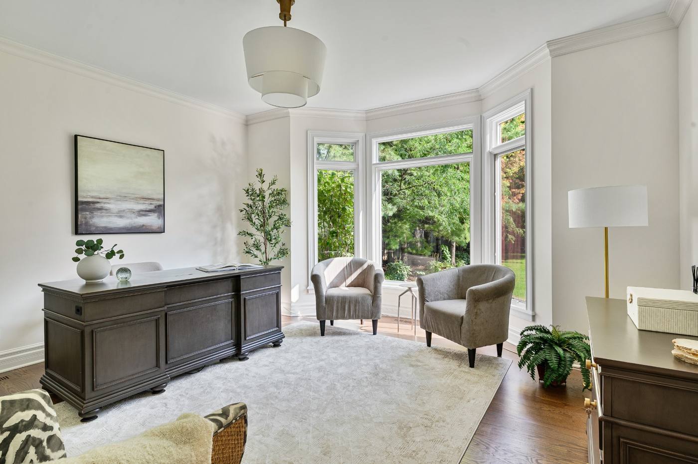 Office from the doorway — desk, seating and the full sweep of the bay window
