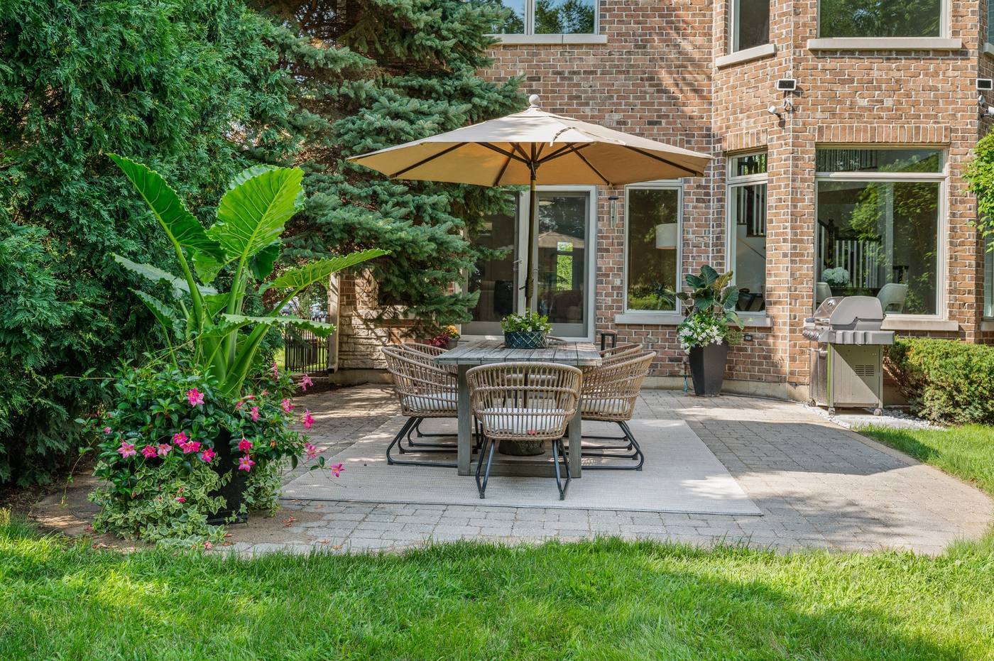 Paver patio with dining terrace and grill, opening off the family room