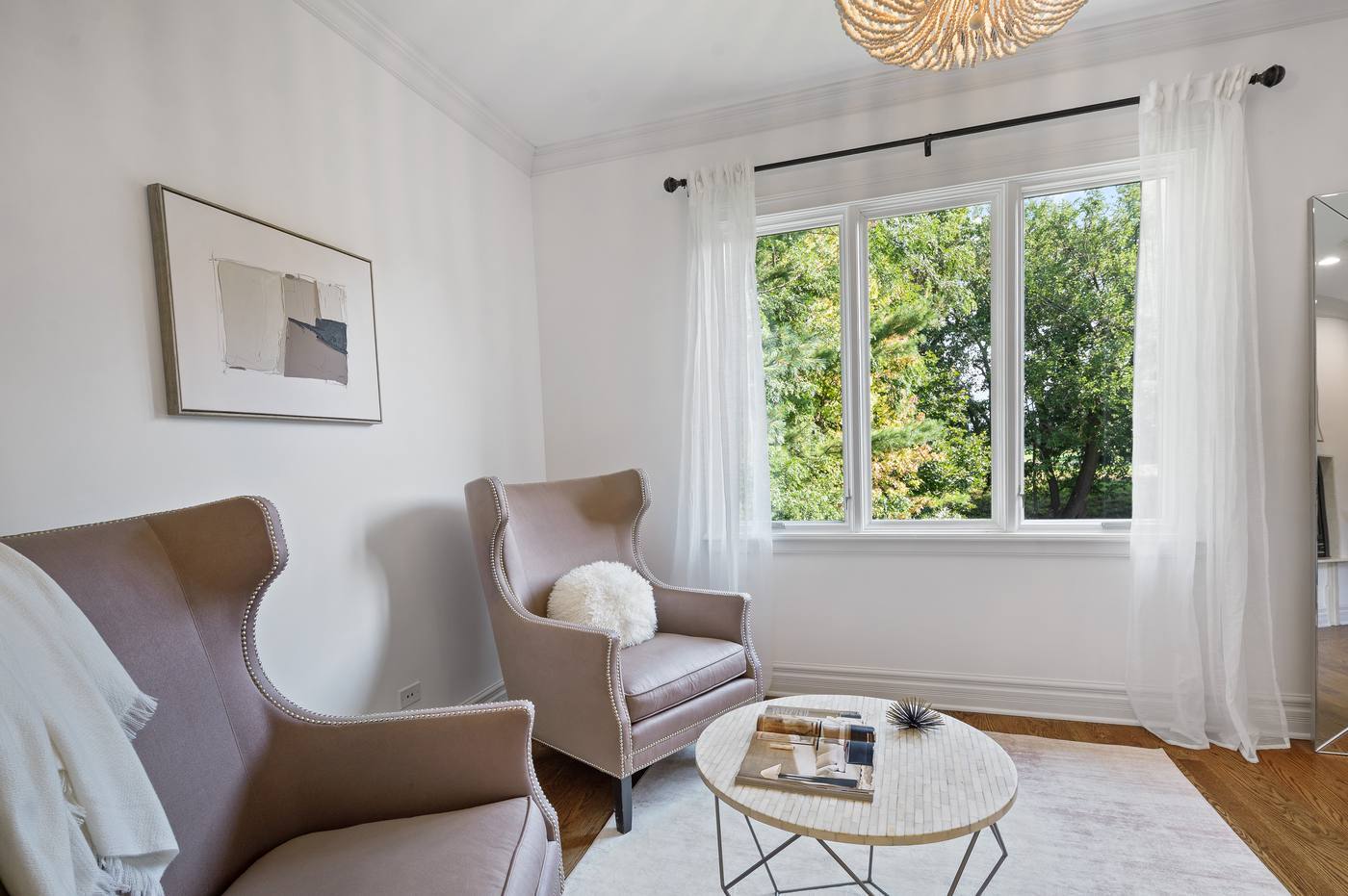Sitting room off the primary bedroom, windows into the treetops