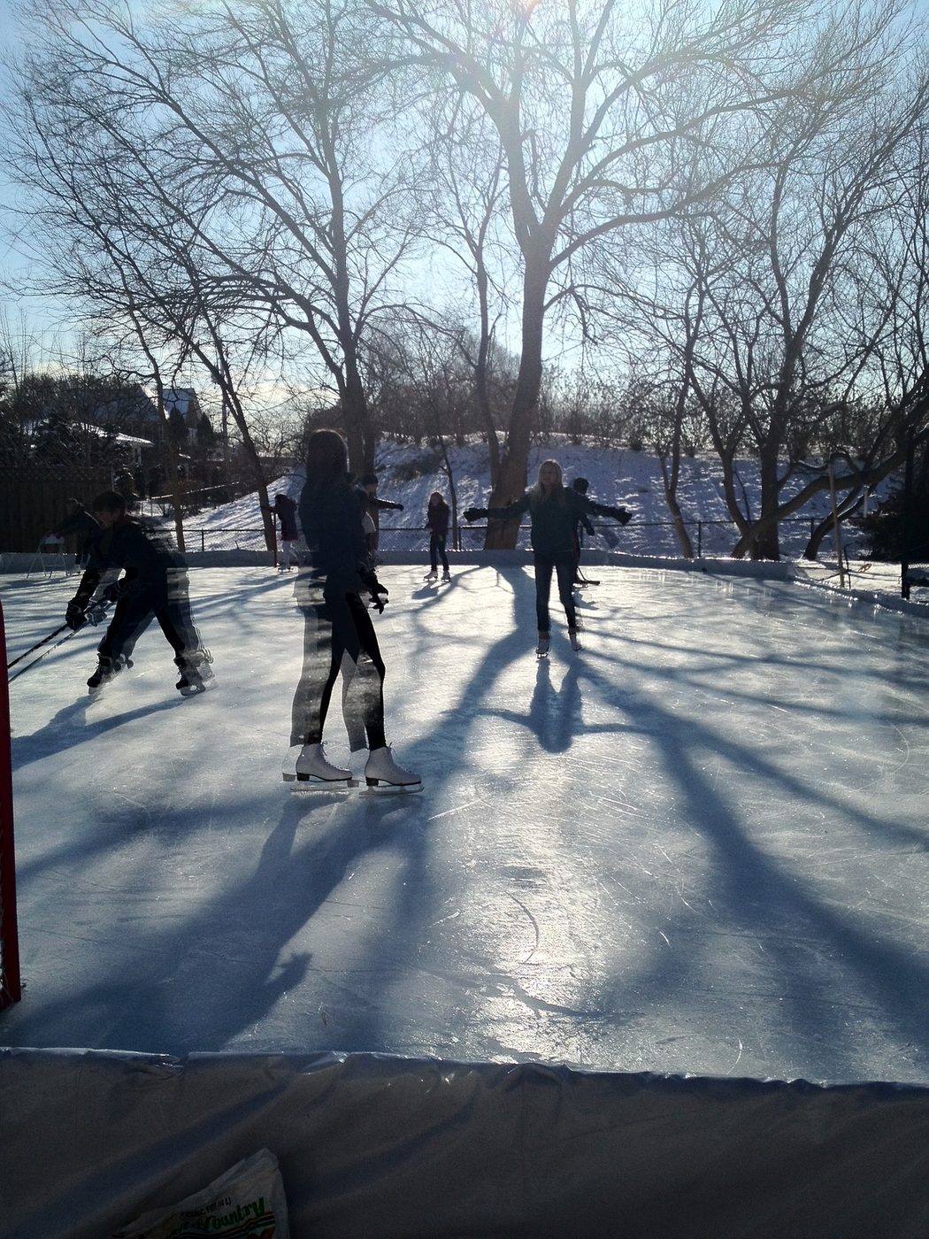 Skaters on the full-width backyard ice rink at 2303 Old Glenview Road on a winter afternoon, historical photograph circa 2013